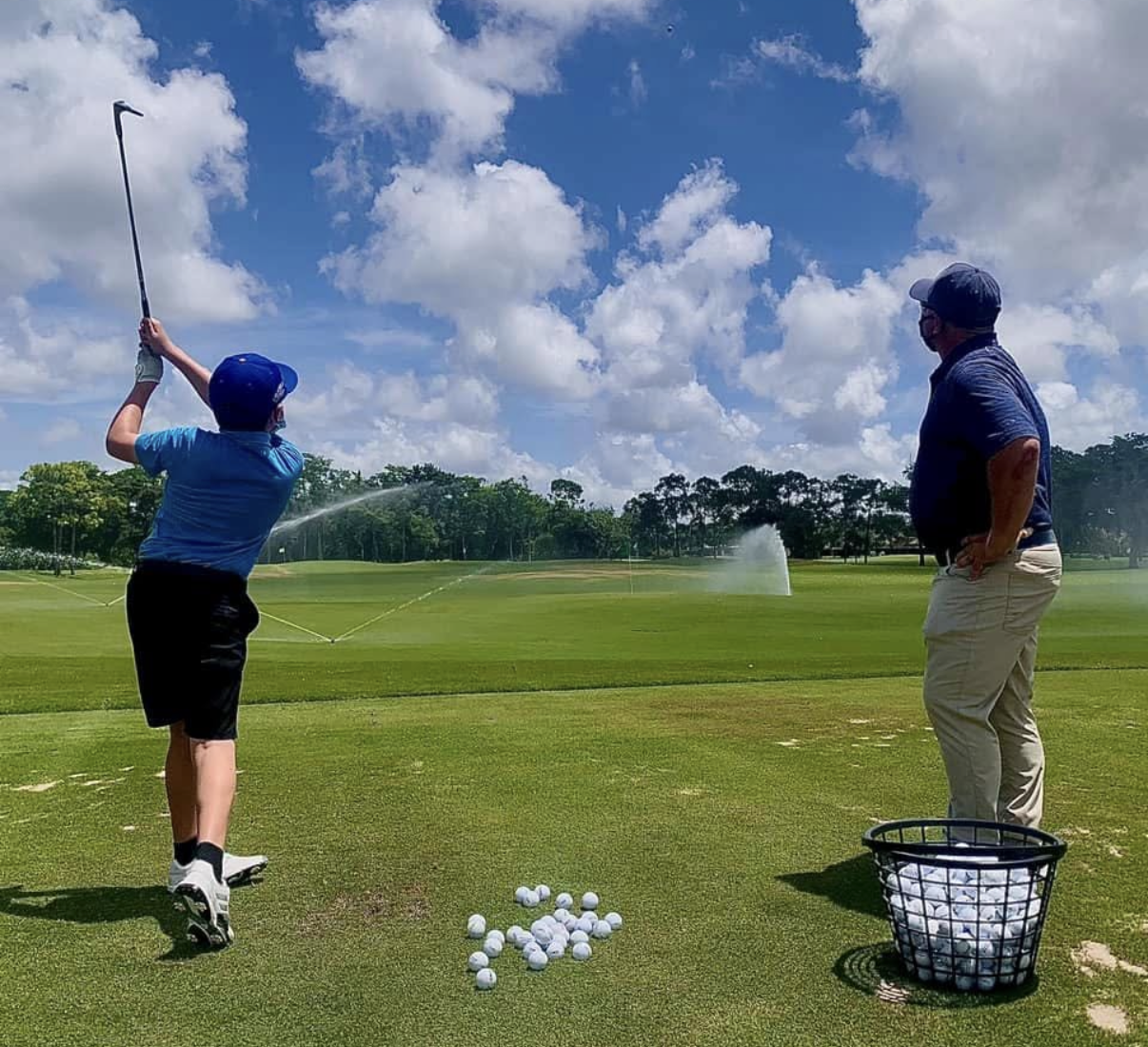 Billy Ashford teaching a golf lesson on the range
